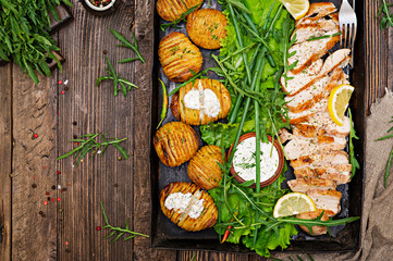 Chicken fillet cooked on a grill with a garnish of baked potatoes. Dietary meal. Healthy food. Top view. Flat lay