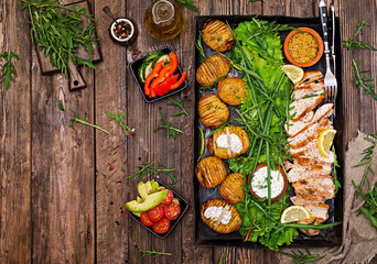 Chicken fillet cooked on a grill with a garnish of baked potatoes. Dietary meal. Healthy food. Top view. Flat lay