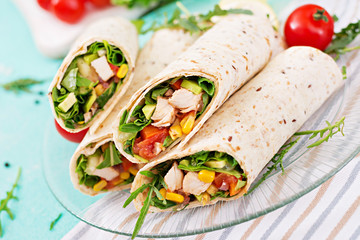 Burritos wraps with chicken and vegetables on light  background. Chicken burrito, mexican food.