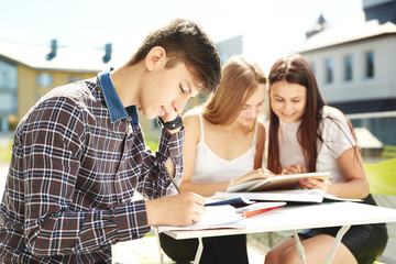 Obraz premium Portrait of three high school students spending time together