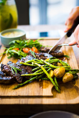 Female having a steak in the restaurant