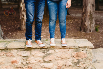 Couple of lovers with green sneakers and standing jeans