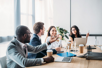 selective focus of multicultural business people having business meeting in office