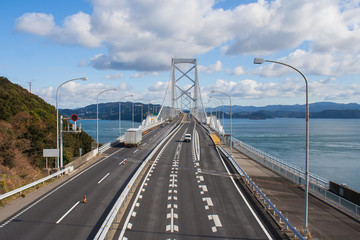 Fototapeta na wymiar Great Naruto bridge cross over ocean. It is a large suspension bridge that stretches across the Naruto Strait.