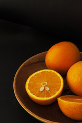 Orange on wooden bowl