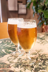 Two glasses of beer on the table in bar