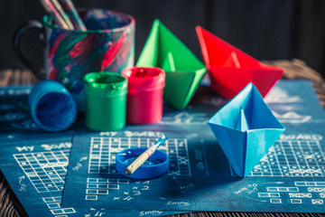 Closeup of battleship paper game with blue and red ships