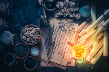 Old scrolls and recipe in vintage laboratory