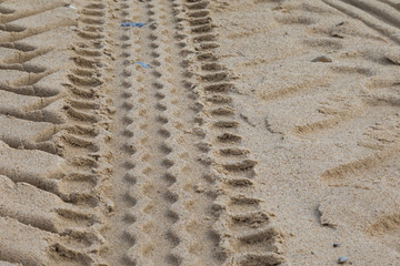 Driving on a sandy beach: tracks left behind