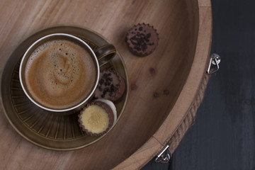 Delicious milk chocolate and morning aromatic coffee. A wooden tray, free space for text. Copy space, flat lay, above
