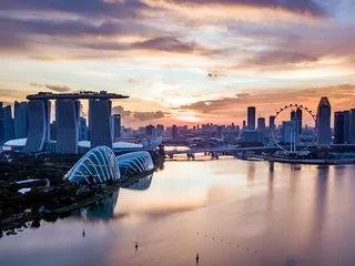 Schilderijen op glas Aerial drone view of Singapore city skyline at sunset © whitcomberd