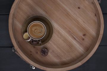 Delicious milk chocolate and morning aromatic coffee. A wooden tray, free space for text. Copy space, flat lay, above