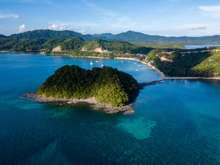 Aerial drone view of Las Cabanas beach in El Nido, Palawan