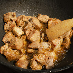 Meat cooking in cauldron