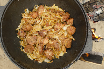 Meat cooking in cauldron