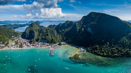 Aerial drone view of boats and mountains surrounding the town of El Nido in Palawan