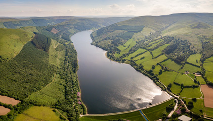 Panoramic aerial view of a large reservoir and dam in Mid Wales