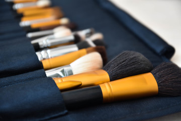 Naklejka premium Professional make-up, brushes and accessories on the table. Equipment of facial make over art. 
