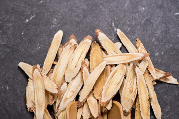 Chinese herbal medicines -- Astragalus on stone background, blank for text, copy space