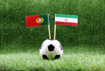ball with Portugal VS Iran flag match on Green grass football 2018