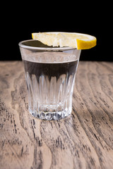 Obraz na płótnie Canvas Vodka shot with lemon slice