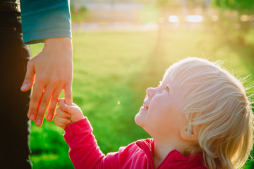 Obraz premium parenting concept- mother holding hand of little daughter