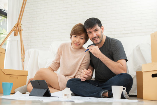 Happy young couple planning their new moving house.