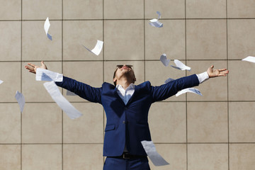 Young businessman throughs away papers standing on the street © IVASHstudio