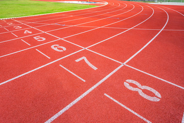 White lines of stadium and texture of running racetrack red rubber racetracks in outdoor stadium...