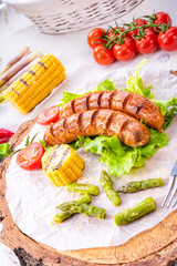 grilled tasty krakauer sausage with boiled corn and green salad