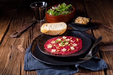 Carpaccio of beef with pine nuts, colorful pepper and Parmesan cheese