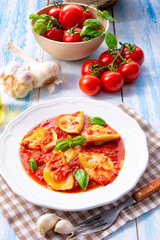 Delicious pasta - ravioli in tomato sauce with basil