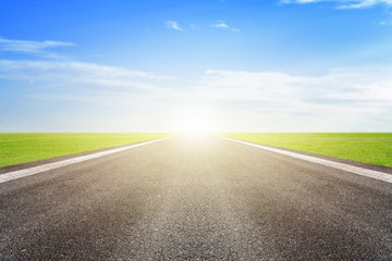 Asphalt road and blue sky background