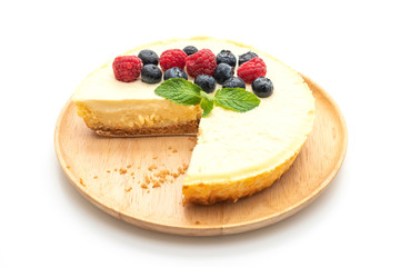 Homemade cheesecake with raspberries and blueberries on white background