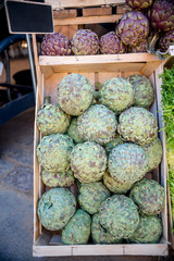 close up view of blank signboard and artichokes