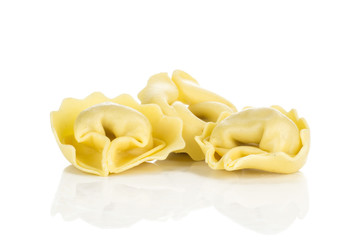 Three raw tortellini pasta isolated on white background Italian.