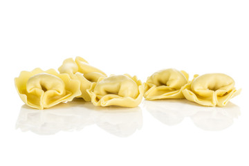 Five raw tortellini pasta isolated on white background Italian traditional dumpling.