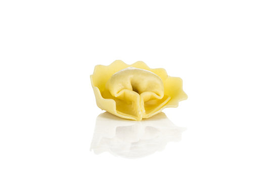 One raw tortellini pasta isolated on white background Italian traditional.