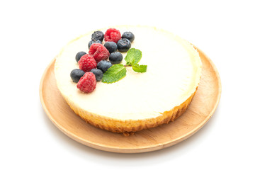 Homemade cheesecake with raspberries and blueberries on white background