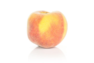 One yellow peach with a red blush isolated on white background.