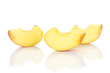 Three yellow peach slices isolated on white background.