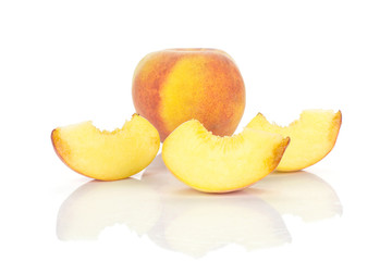 One yellow peach and three slices isolated on white background.