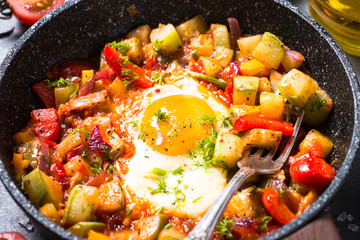 Fried egg with vegetables. 