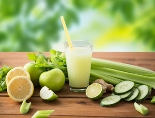 healthy eating, food, dieting and vegetarian concept - glass of green juice with fruits and...