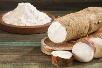Fototapeta na wymiar Raw cassava starch - Manihot esculenta. Wooden background