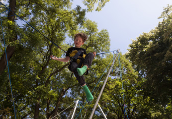 Little boy playing on a bungee trampoline