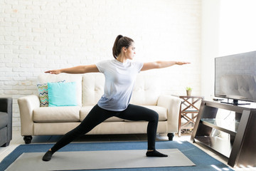 Attractive young woman practising yoga