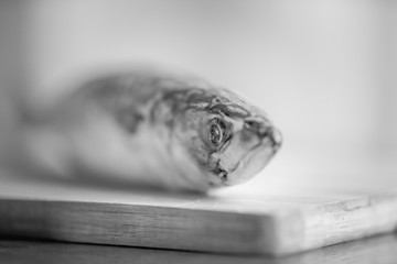 fish mackerel on the table close-up with bokeh