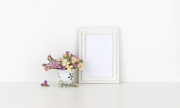 Vertical wooden frame mockup with flowers on white background