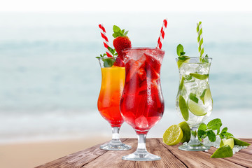 Summer time and glasses of drink on wooden table. 